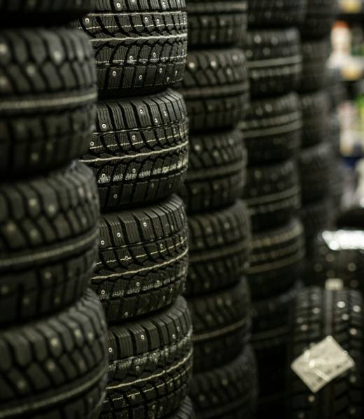 Sale of car tires for sale in the store. Many new winter tires lie